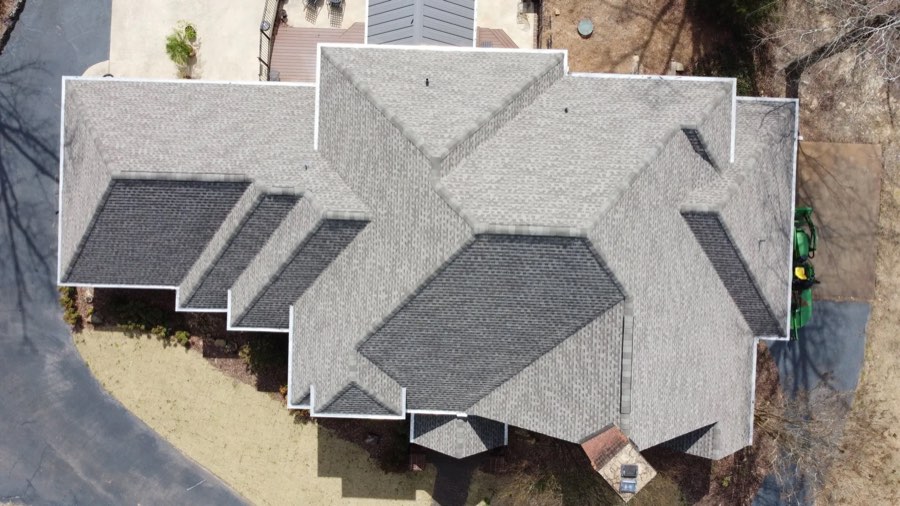 Aerial view of a complex multi-gable shingle roof after replacement